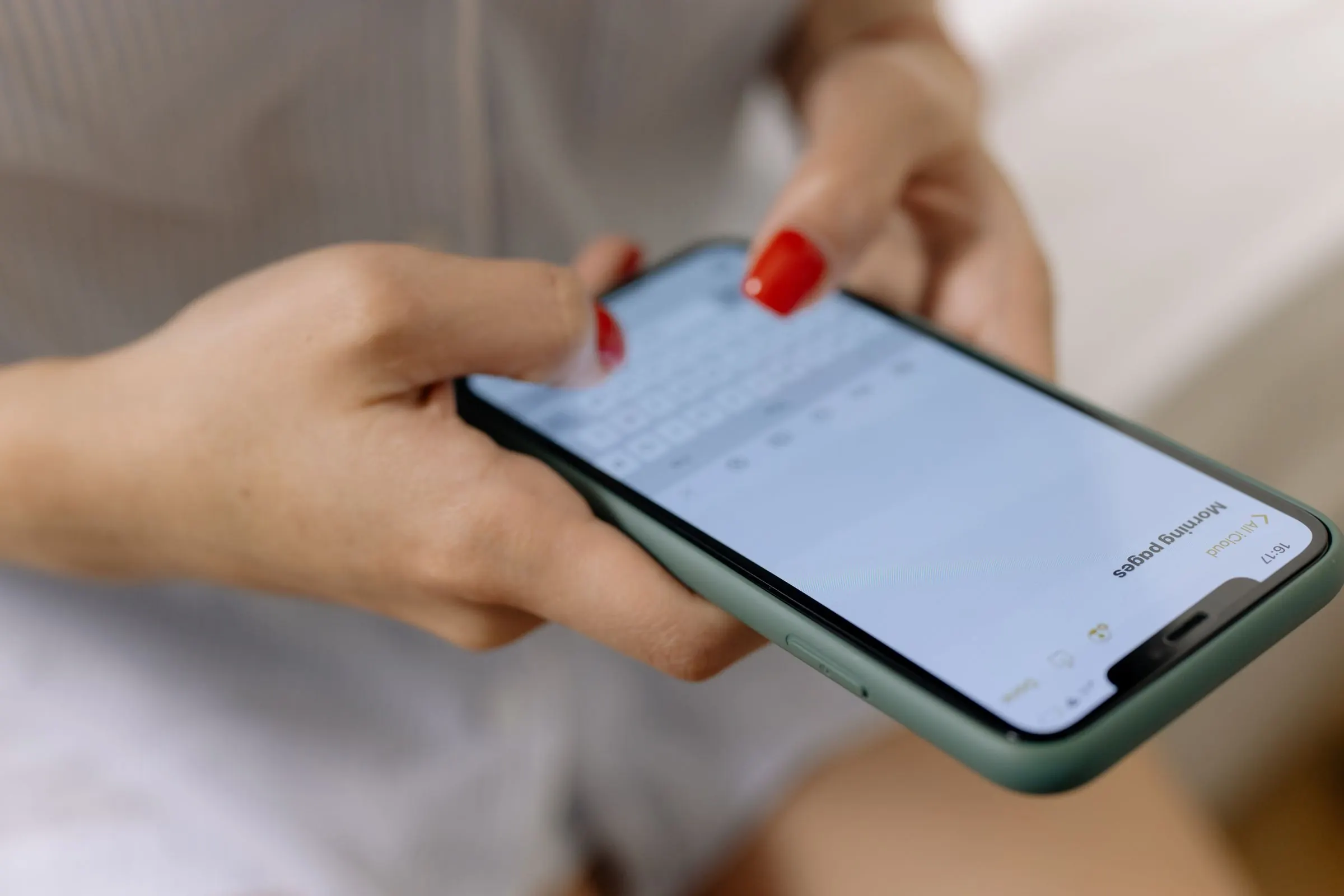 Close-up of a woman typing on her phone.